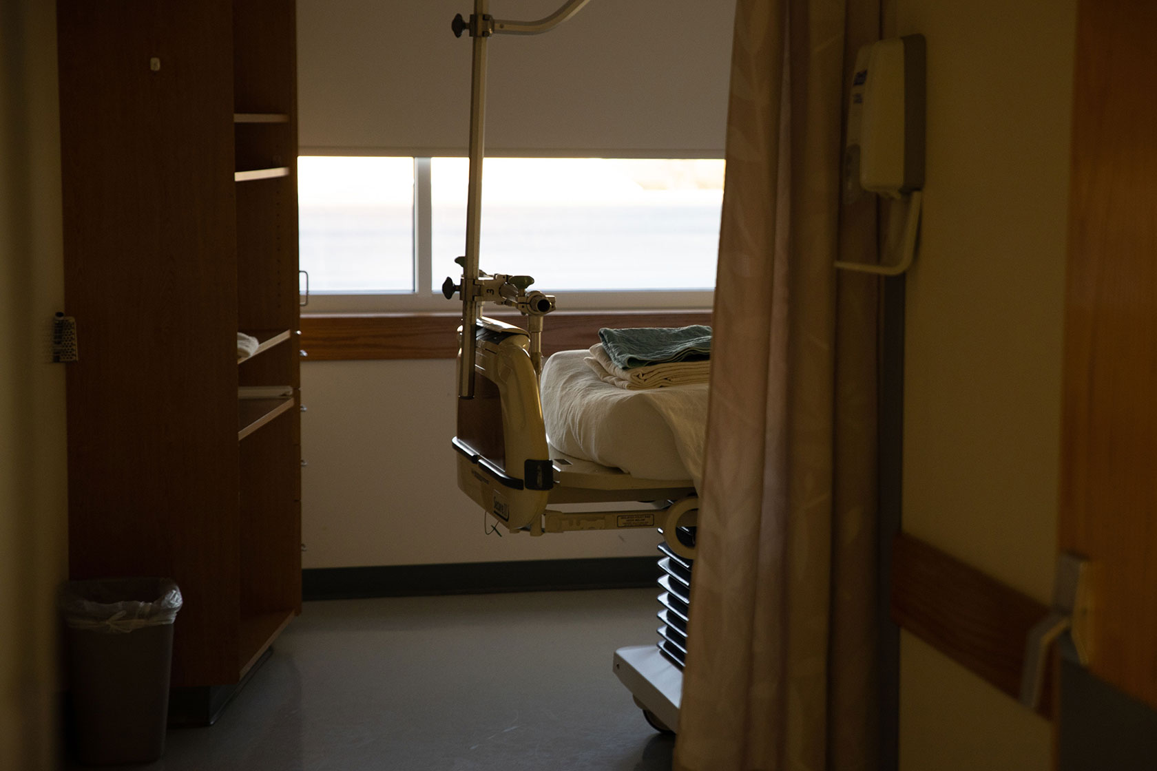 End of a hospital bed seen through a door